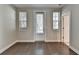 Bedroom with hardwood floors, natural light from windows, and a door leading to the outside at 595 Broadview Ne Pl, Atlanta, GA 30324