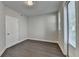 A cozy bedroom featuring hardwood floors and a sunlit window with blind at 595 Broadview Ne Pl, Atlanta, GA 30324
