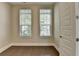 Cozy bedroom with natural light from two windows and hardwood floors at 595 Broadview Ne Pl, Atlanta, GA 30324