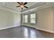 Spacious bedroom with tray ceiling, dark wood floors and windows at 595 Broadview Ne Pl, Atlanta, GA 30324