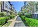 Community walkway featuring well-maintained hedges and manicured trees between townhomes at 595 Broadview Ne Pl, Atlanta, GA 30324