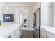 Contemporary kitchen with white cabinetry, stainless steel appliances, and an open view to the bedroom at 595 Broadview Ne Pl, Atlanta, GA 30324