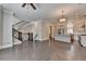 Living area with staircase, hardwood floors, stainless steel appliances, kitchen island, and neutral paint at 595 Broadview Ne Pl, Atlanta, GA 30324