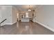 Open-concept living room has hardwood floors, stainless kitchen appliances, neutral paint, and a kitchen island at 595 Broadview Ne Pl, Atlanta, GA 30324