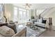 Inviting living room with bright windows, comfortable seating, and a staircase at 595 Broadview Ne Pl, Atlanta, GA 30324