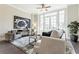 Cozy living room featuring elegant decor, ample seating, and a decorative ceiling fan at 595 Broadview Ne Pl, Atlanta, GA 30324
