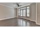 This bright living room features hardwood floors, neutral paint, large windows and French doors, and elegant crown molding at 595 Broadview Ne Pl, Atlanta, GA 30324