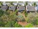 Aerial view of a home with a backyard pool surrounded by mature trees and greenery at 68 Highcrest Dr, Acworth, GA 30101