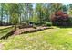 Lush backyard with terraced landscaping and a cozy seating area at 68 Highcrest Dr, Acworth, GA 30101