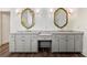 Bathroom includes double sink vanity with framed mirrors and wood-look tile floors at 68 Highcrest Dr, Acworth, GA 30101