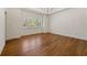 Spacious bedroom boasts hardwood floors, plantation shutters, and a stylish chandelier at 68 Highcrest Dr, Acworth, GA 30101