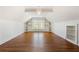 Open bonus room with hardwood floors, built in bookshelves, and chandelier at 68 Highcrest Dr, Acworth, GA 30101