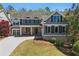 Charming two-story home with gray siding, brick accents, manicured lawn, and attached two-car garage at 68 Highcrest Dr, Acworth, GA 30101