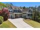 Attractive two-story home with gray siding, brick accents, front porch, manicured lawn, and two-car garage at 68 Highcrest Dr, Acworth, GA 30101