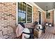 Inviting front porch with brick accents, seating, and decorative plants at 68 Highcrest Dr, Acworth, GA 30101