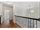 Hallway with hardwood floors, black railing, and a chandelier at 68 Highcrest Dr, Acworth, GA 30101
