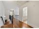 Hallway with hardwood floors and black iron railing leads to a bathroom at 68 Highcrest Dr, Acworth, GA 30101
