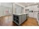 Stylish kitchen island with white countertops and custom cabinets adjacent to the living room at 68 Highcrest Dr, Acworth, GA 30101