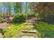 Lush landscaping with stone steps and vibrant ground cover at 68 Highcrest Dr, Acworth, GA 30101