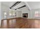 Bright living room showcasing a fireplace, hardwood floors, and large windows at 68 Highcrest Dr, Acworth, GA 30101