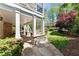 Covered patio with stone columns and walkway overlooking the manicured garden at 68 Highcrest Dr, Acworth, GA 30101