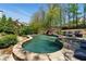 Beautiful pool with a stone edge and surrounding landscaping at 68 Highcrest Dr, Acworth, GA 30101