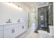 Modern bathroom featuring double vanity, sleek cabinets, and glass shower at 876 Bramlett Shoals Rd, Lawrenceville, GA 30045