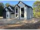 Stately two-story home showcasing a modern design with contrasting black and white brick and a two-car garage at 876 Bramlett Shoals Rd, Lawrenceville, GA 30045