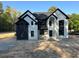Striking two-story home with black and white brickwork, gabled roof, and a grand arched entrance at 876 Bramlett Shoals Rd, Lawrenceville, GA 30045