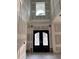 Grand foyer features a soaring ceiling, beautiful front door and decorative paneling at 876 Bramlett Shoals Rd, Lawrenceville, GA 30045