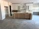 Spacious kitchen with ample cabinets, a large island and a view into the living space at 876 Bramlett Shoals Rd, Lawrenceville, GA 30045