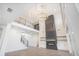 Open-concept living room featuring high ceilings, fireplace, and staircase at 876 Bramlett Shoals Rd, Lawrenceville, GA 30045