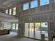 Bright, open-concept living space with soaring ceilings, a balcony, and floor-to-ceiling windows at 876 Bramlett Shoals Rd, Lawrenceville, GA 30045