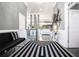 Stunning foyer with a striking black and white rug design, complemented by elegant gray walls and modern decor at 1837 Miramonte Way, Lawrenceville, GA 30045