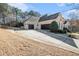 Spacious three-car garage with extended driveway and manicured landscaping complementing the beautiful brick exterior at 1837 Miramonte Way, Lawrenceville, GA 30045