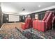 Dedicated home theater room with tiered seating, projector screen, and ambient lighting at 1837 Miramonte Way, Lawrenceville, GA 30045