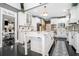 Bright kitchen features white cabinetry, marble countertops, stainless steel appliances, and a center island with a breakfast bar at 1837 Miramonte Way, Lawrenceville, GA 30045