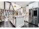 Bright kitchen features white cabinetry, marble countertops, stainless steel appliances, a center island, and vaulted ceiling at 1837 Miramonte Way, Lawrenceville, GA 30045