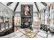 Living area with stone fireplace, vaulted ceilings, statement lighting, comfortable seating, and glass coffee table at 1837 Miramonte Way, Lawrenceville, GA 30045