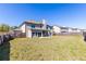 Expansive backyard with a well-kept lawn, a covered patio, and a secure fence at 3728 In Bloom Way, Auburn, GA 30011