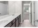 Bathroom featuring gray tile floors, double sink vanity, and a bright window at 3728 In Bloom Way, Auburn, GA 30011