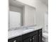 Bright bathroom featuring a granite countertop vanity, large mirror, and modern fixtures at 3728 In Bloom Way, Auburn, GA 30011