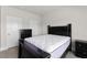 Bedroom featuring a black bedframe, gray carpet, and white walls at 3728 In Bloom Way, Auburn, GA 30011