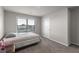 Neutral bedroom with a comfortable bed, window, and plush carpeting at 3728 In Bloom Way, Auburn, GA 30011