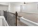 Bonus room featuring neutral carpet, ceiling fan, and a large window at 3728 In Bloom Way, Auburn, GA 30011