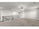 Spacious bonus room with a modern ceiling fan, neutral walls, and plush carpeting at 3728 In Bloom Way, Auburn, GA 30011