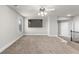 Spacious bonus room features neutral walls, plush carpeting, and modern ceiling fan at 3728 In Bloom Way, Auburn, GA 30011