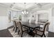 Bright dining area with coffered ceilings, wainscoting and open access to living area at 3728 In Bloom Way, Auburn, GA 30011