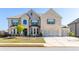 Charming two-story brick home with a three-car garage, well-manicured lawn and inviting curb appeal at 3728 In Bloom Way, Auburn, GA 30011