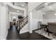 Bright entryway with dark wood floors, staircase, and views into the living and dining room at 3728 In Bloom Way, Auburn, GA 30011